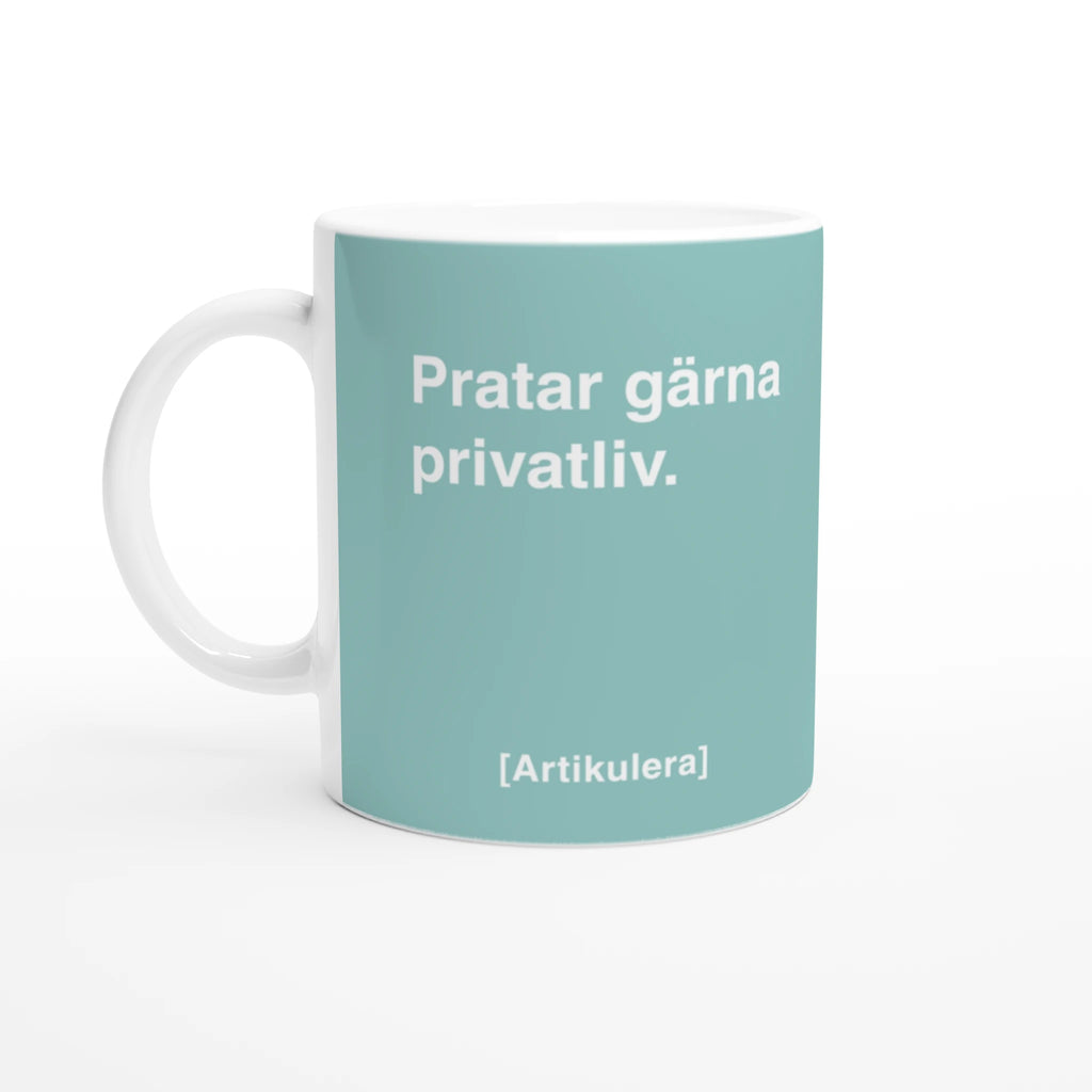 Vit mugg med ljust blågrönt tryck, vit text ”Pratar gärna privatliv.” samt vit Artikulera-logotyp